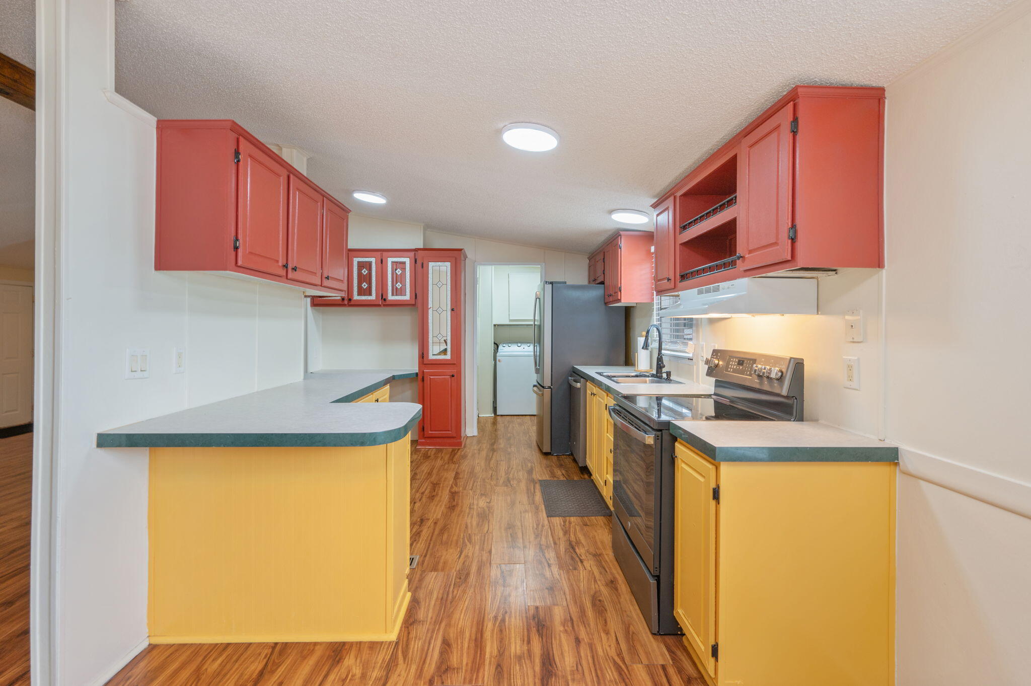 1314 Riddle Drive Westville, FL 32464 - Photo 11 of 35 a kitchen with stainless steel appliances granite countertop a sink and a stove top oven