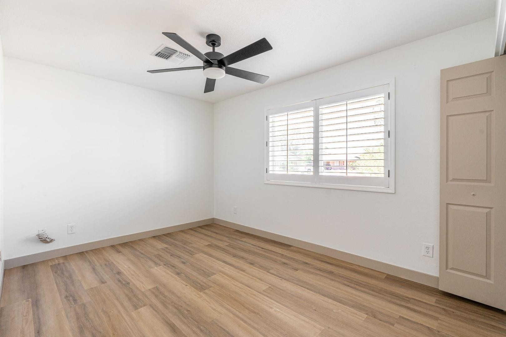 5739 West Monte Vista Road Phoenix, AZ 85035 - Photo 11 of 23 wooden floor in an empty room with a window