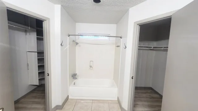 a bathroom with a tub and a shower