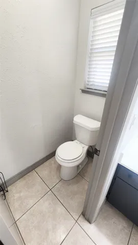 a white toilet sitting next to a window