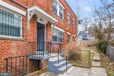a view of a brick house with many windows