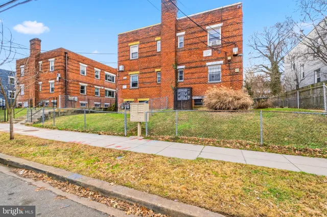 a view of a big building with a big yard and potted plants