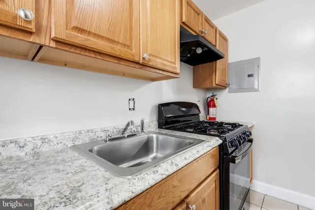 a kitchen with stainless steel appliances granite countertop a sink a stove and a microwave