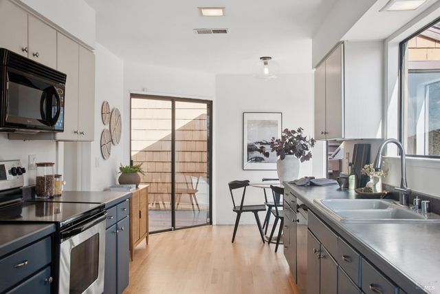 a kitchen with stainless steel appliances granite countertop a sink stove and microwave