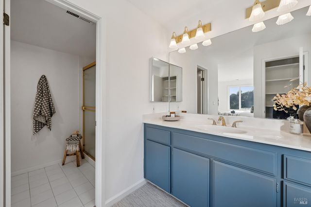 a bathroom with a double vanity sink and a mirror