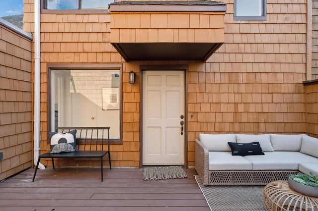 a view of a balcony with two chairs and a couch