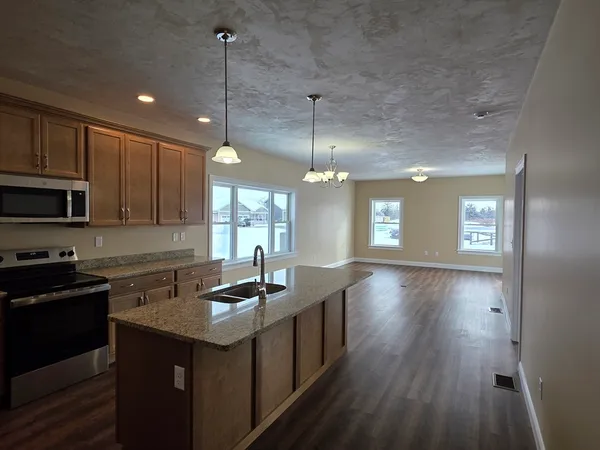 a kitchen with sink cabinets and wooden floor