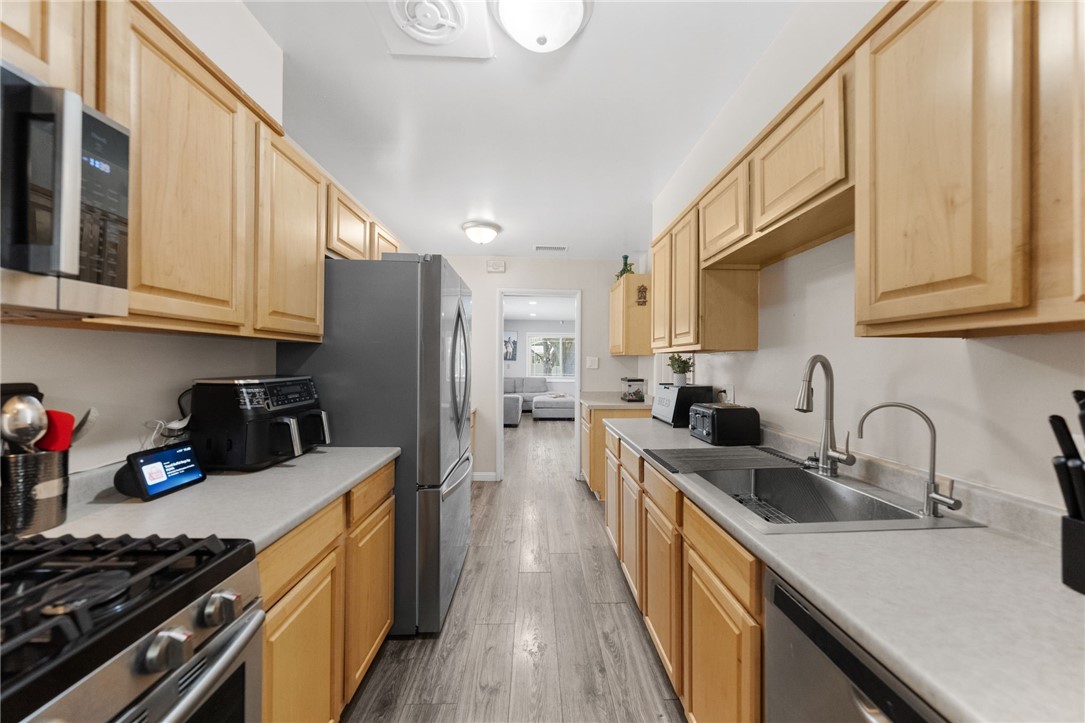 4869 Serrano Place Riverside, CA 92504 - Photo 24 of 40 Spacious kitchen with extended counter space, modern fixtures, and a practical layout for cooking and entertaining.