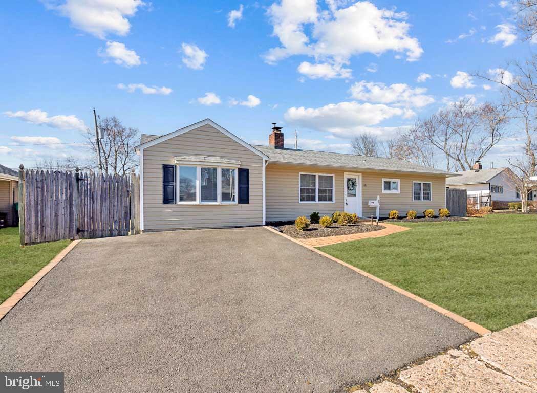 65 Gentle Road Levittown, PA 19057 - Photo 2 of 27 a front view of a house with a yard and garage