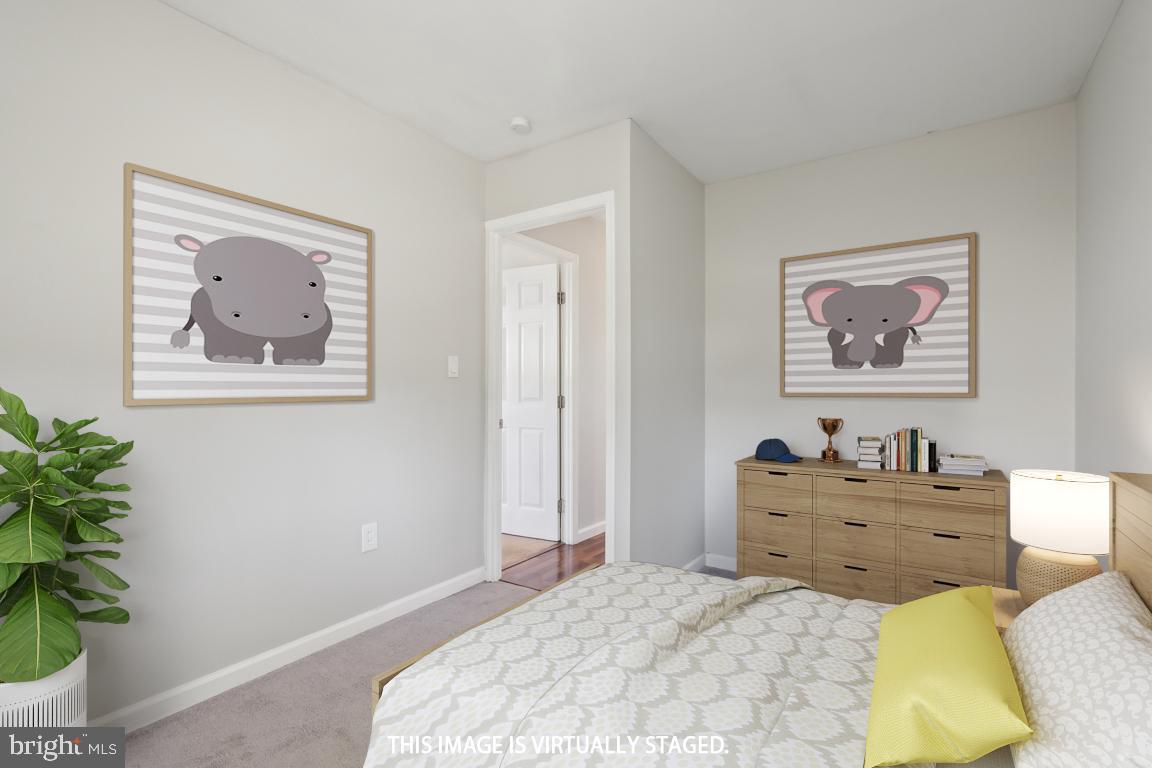 65 Gentle Road Levittown, PA 19057 - Photo 21 of 27 a bedroom with a bed and a potted plant