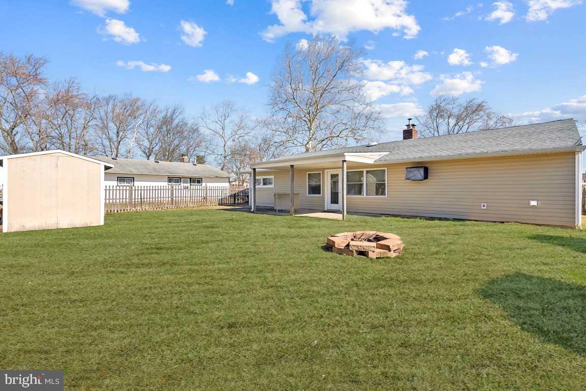 65 Gentle Road Levittown, PA 19057 - Photo 27 of 27 a backyard of a house with table and chairs