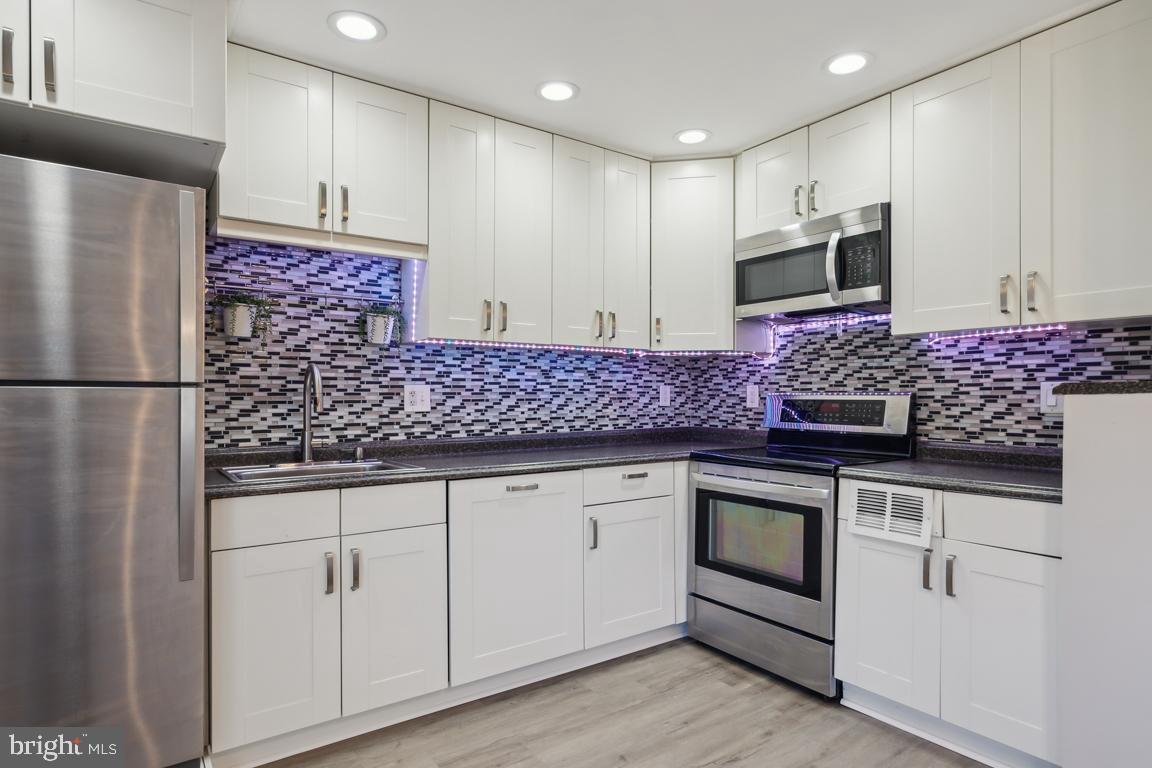 65 Gentle Road Levittown, PA 19057 - Photo 6 of 27 a kitchen with stainless steel appliances granite countertop a sink stove and refrigerator