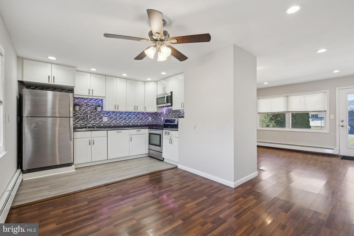 65 Gentle Road Levittown, PA 19057 - Photo 7 of 27 a kitchen with stainless steel appliances kitchen island granite countertop a refrigerator and a stove top oven