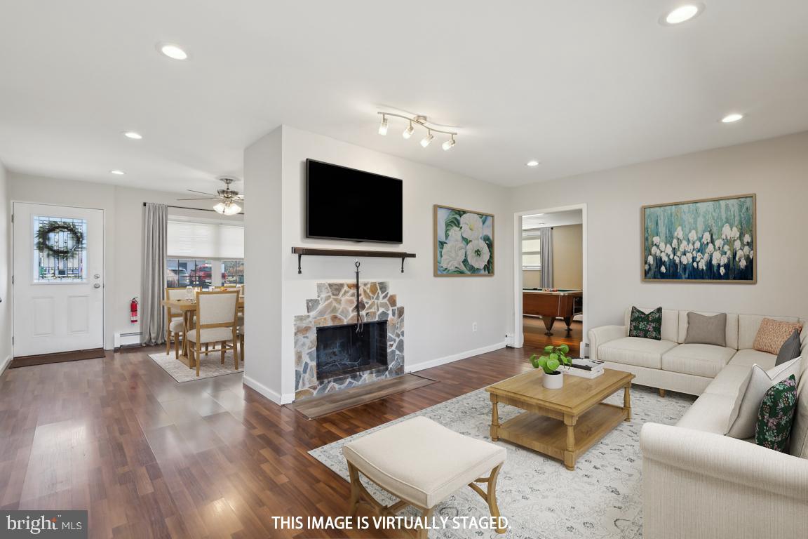 65 Gentle Road Levittown, PA 19057 - Photo 8 of 27 a living room with furniture a flat screen tv and a fireplace
