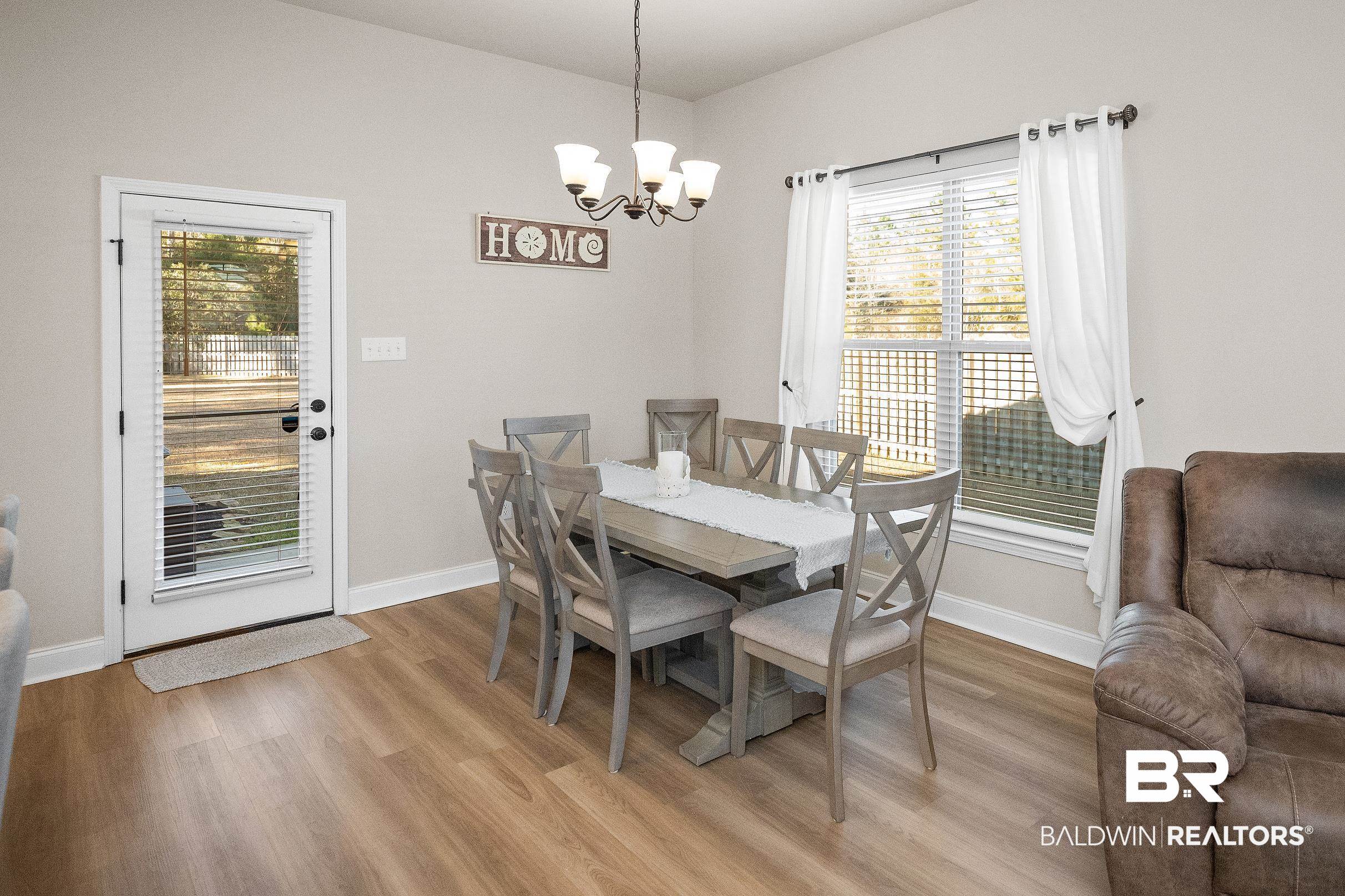 1077 Stella Road Foley, AL 36535 - Photo 13 of 27 Dining room with light wood-style flooring and hanging lights