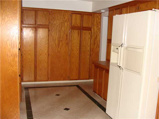 543 Rimrock Road El Cajon, CA 92020 - Photo 12 of 13 The other side of the kitchen with doorway entering into family room with built in cabinets and Book Shelf