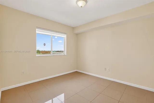 a bedroom with a bed and a potted plant