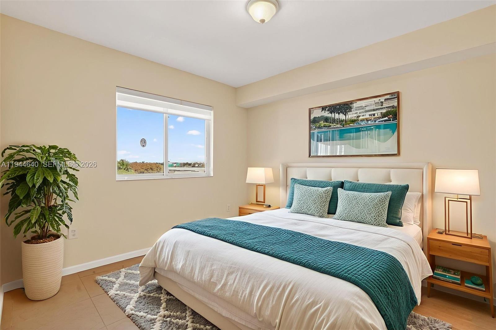 11060 Southwest 196th Street, Unit 605 Cutler Bay, FL 33157 - Photo 16 of 26 a bedroom with a bed and a potted plant