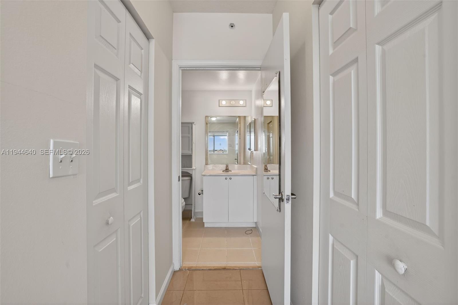 11060 Southwest 196th Street, Unit 605 Cutler Bay, FL 33157 - Photo 18 of 26 a bathroom with a glass shower door