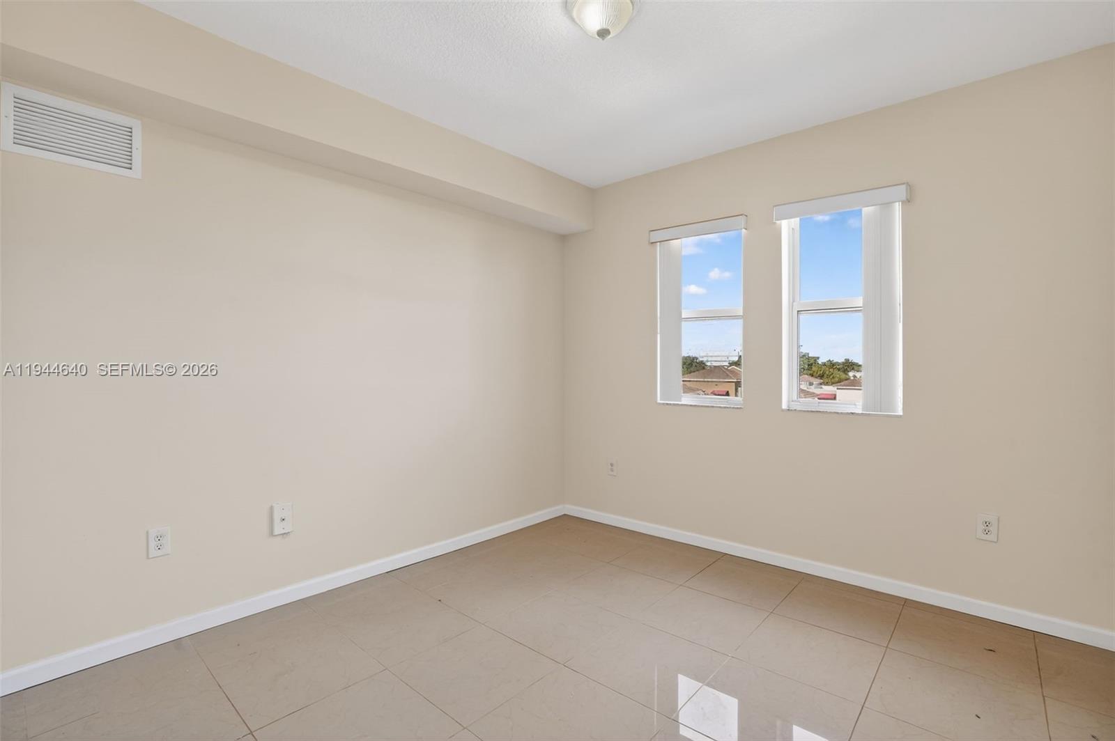 11060 Southwest 196th Street, Unit 605 Cutler Bay, FL 33157 - Photo 21 of 26 an empty room with a window