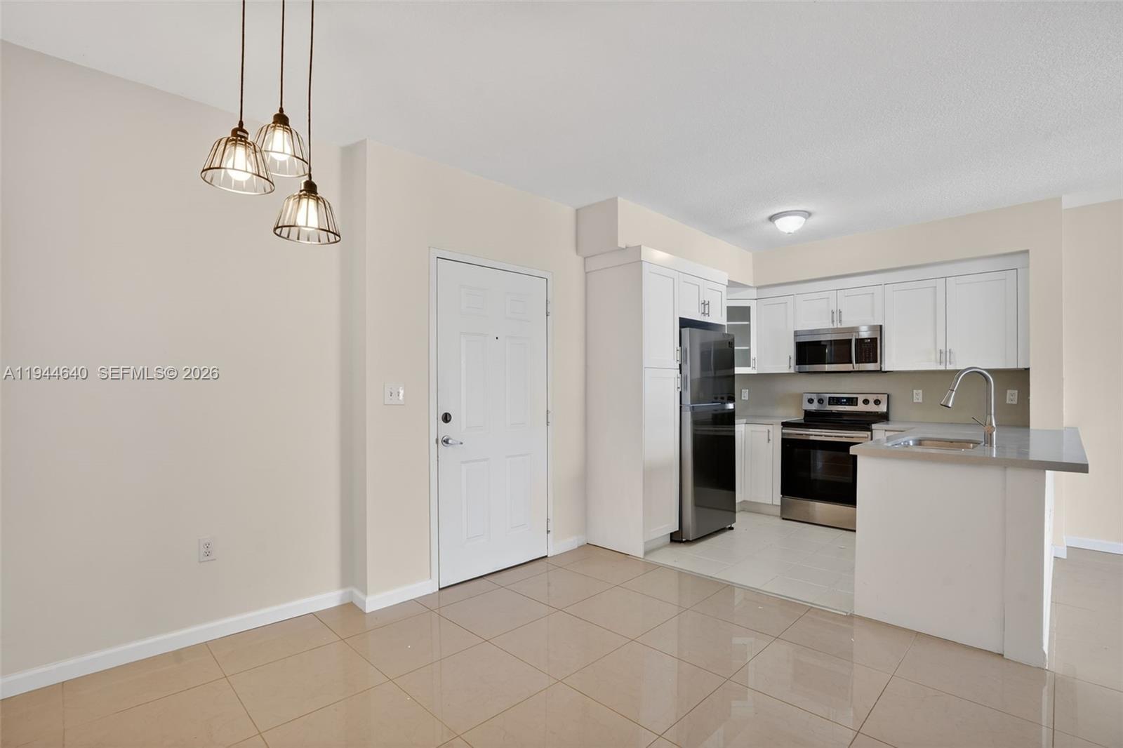 11060 Southwest 196th Street, Unit 605 Cutler Bay, FL 33157 - Photo 6 of 26 a kitchen with stainless steel appliances granite countertop a refrigerator and a sink