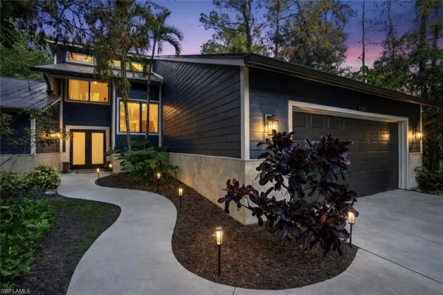 a view of a house with potted plants