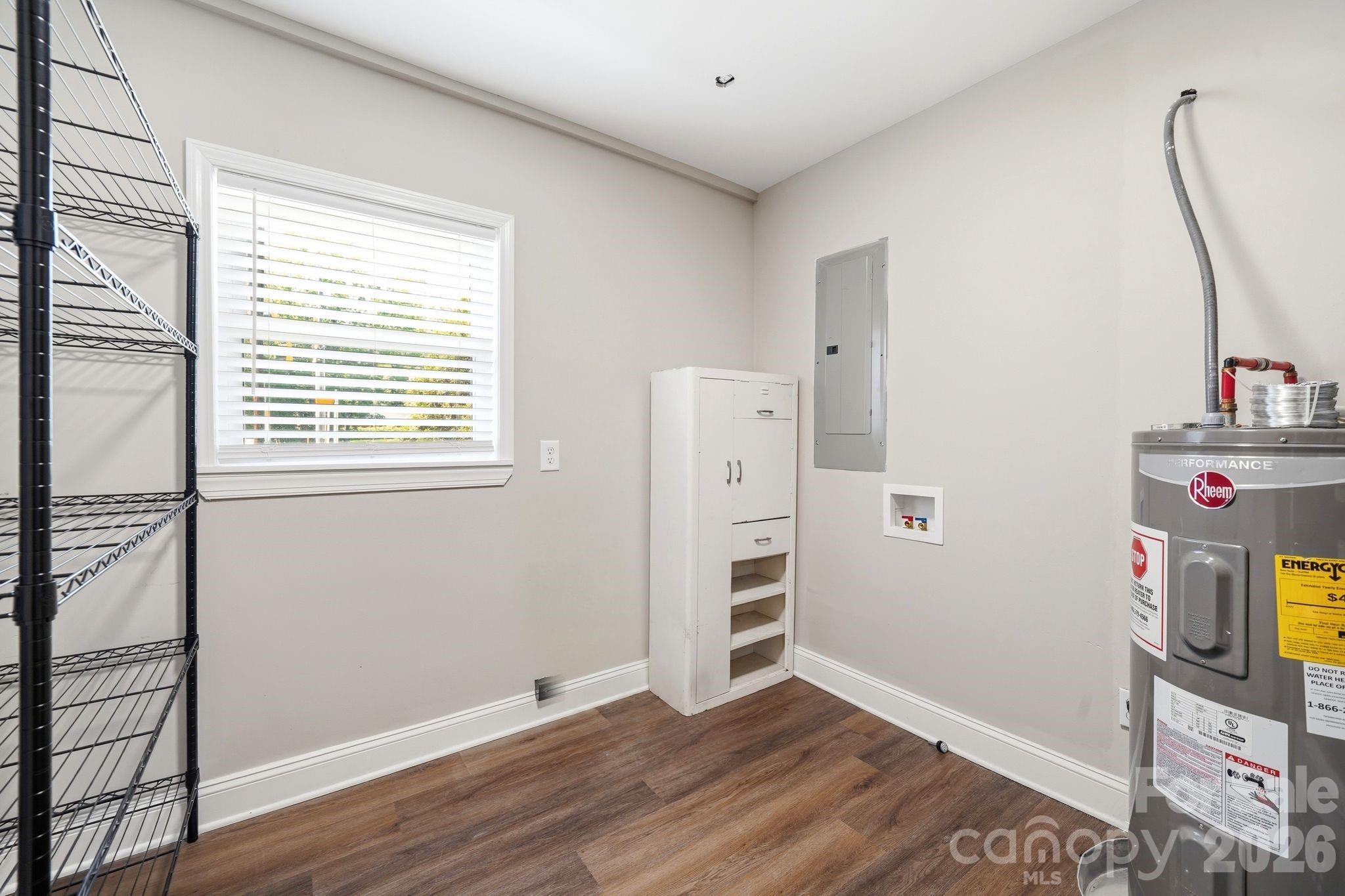7552 Idlewild Road Charlotte, NC 28212 - Photo 29 of 40 a view of empty room with wooden floor and cabinet