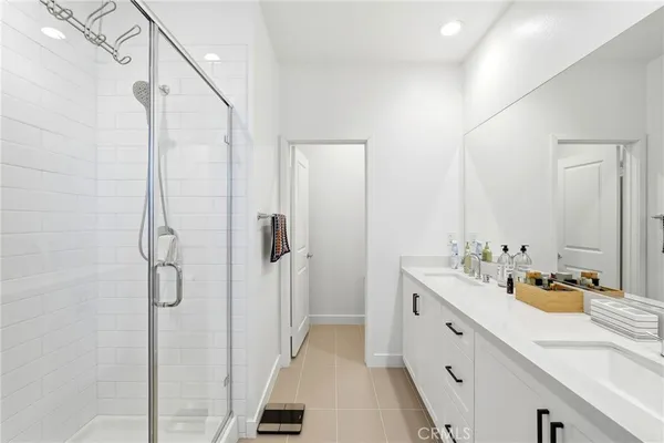 a spacious bathroom with a double vanity sink mirror and double