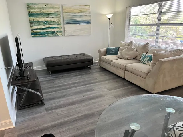 a kitchen with a refrigerator and white cabinets