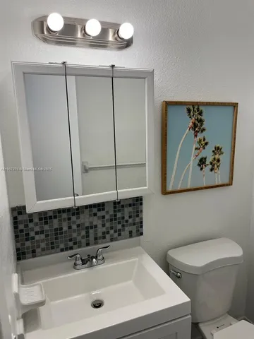 a bedroom with a bed and a mirror