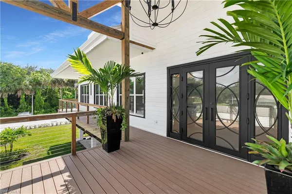 a view of a dining room with furniture wooden floor and chandelier
