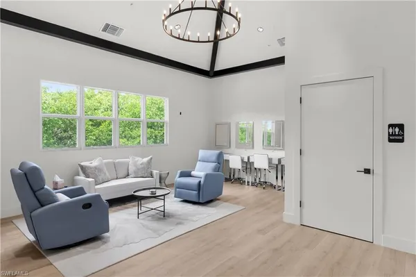 a living room with furniture and a large window