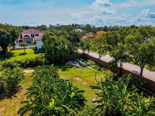 an aerial view of a house with a yard and lake view