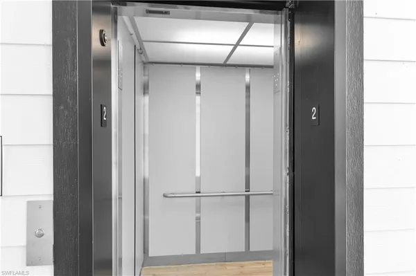 a view of a entryway with plants and wooden floor