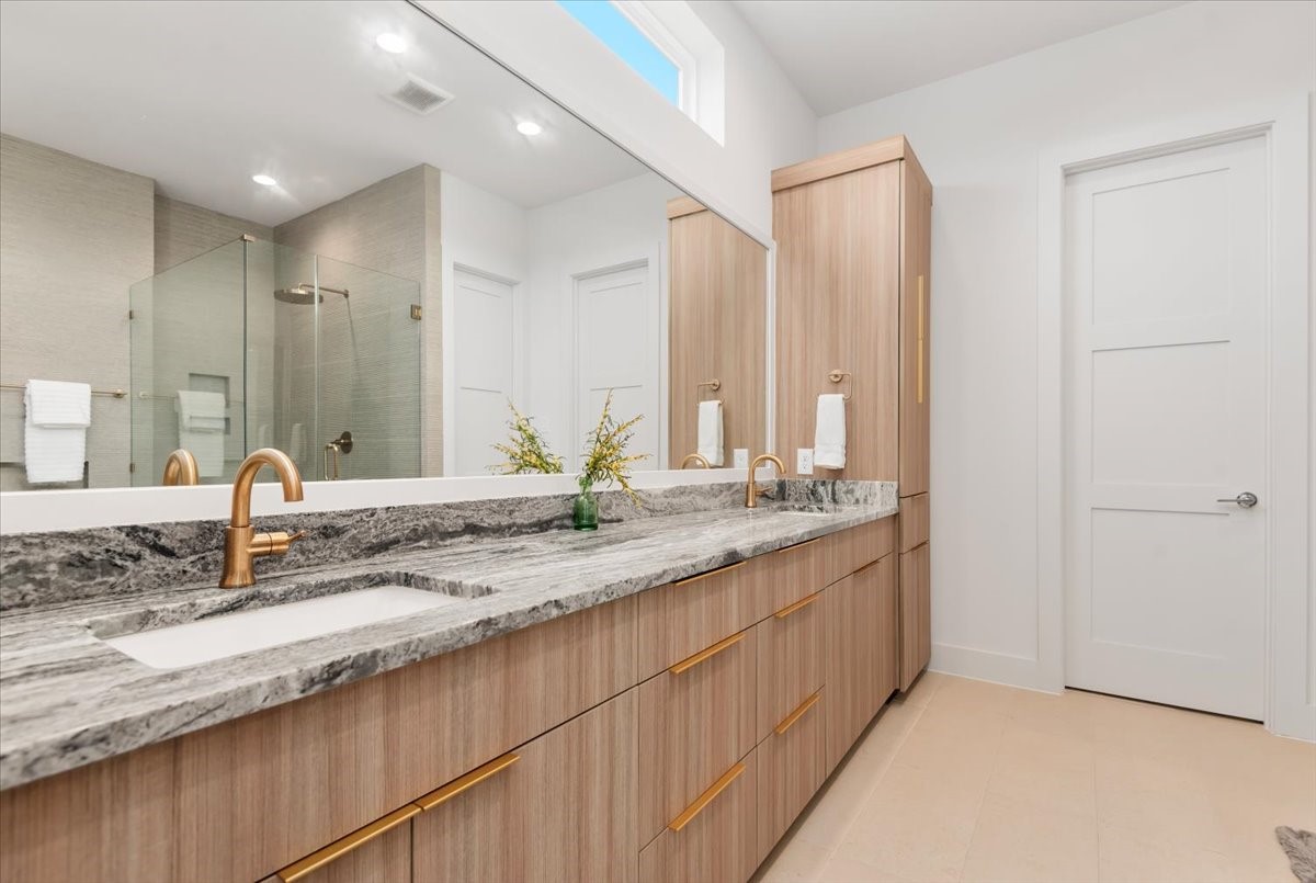 5203 Texas Street Houston, TX 77011 - Photo 11 of 20 Double sinks, classic mixed metals with a linen closet.