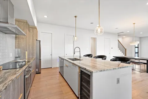 a kitchen with a sink stove and wooden cabinets