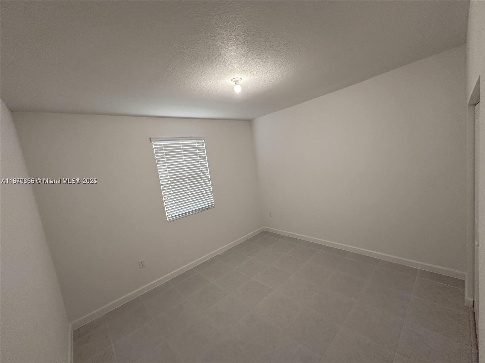 14804 Southwest 162nd Street Miami, FL 33177 - Photo 2 of 6 an empty room with a empty space and window