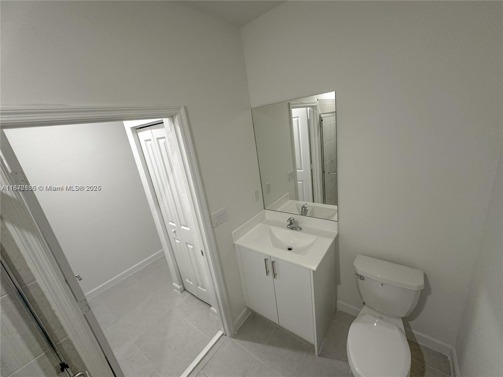 14804 Southwest 162nd Street Miami, FL 33177 - Photo 5 of 6 a bathroom with a toilet sink and mirror