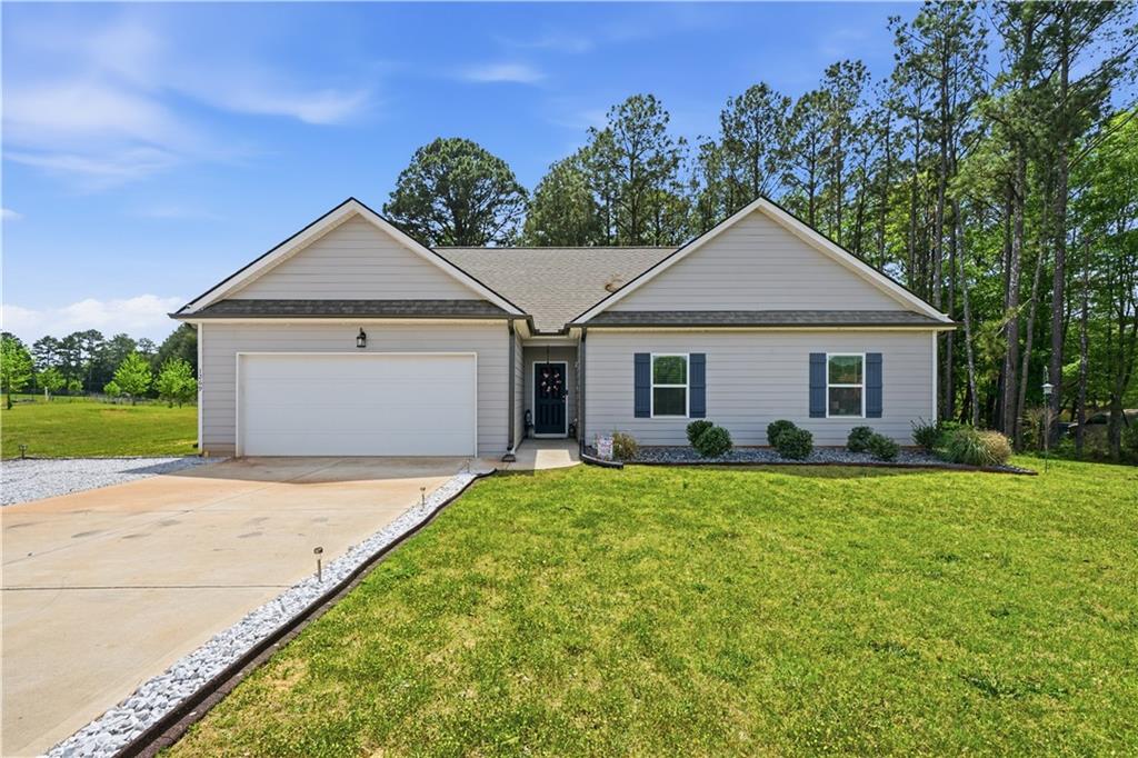 1269 Covered Bridge Road Covington, GA 30016 - Photo 1 of 31 a front view of a house with a garden and yard