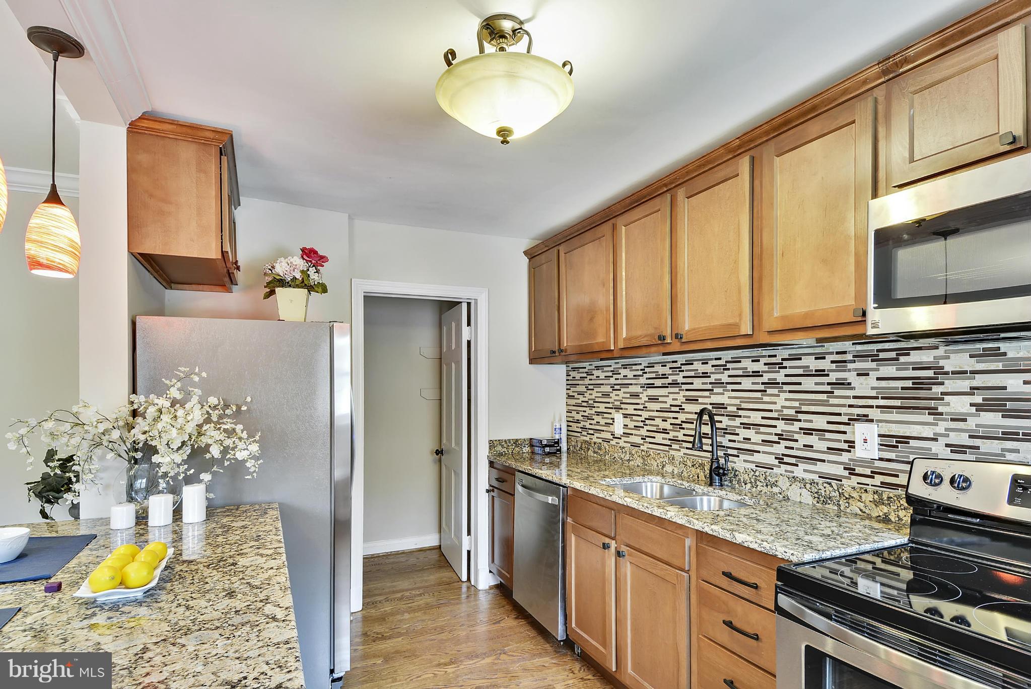1602 Heathfield Road Baltimore, MD 21239 - Photo 1 of 27 a kitchen with stainless steel appliances granite countertop a stove refrigerator and cabinets