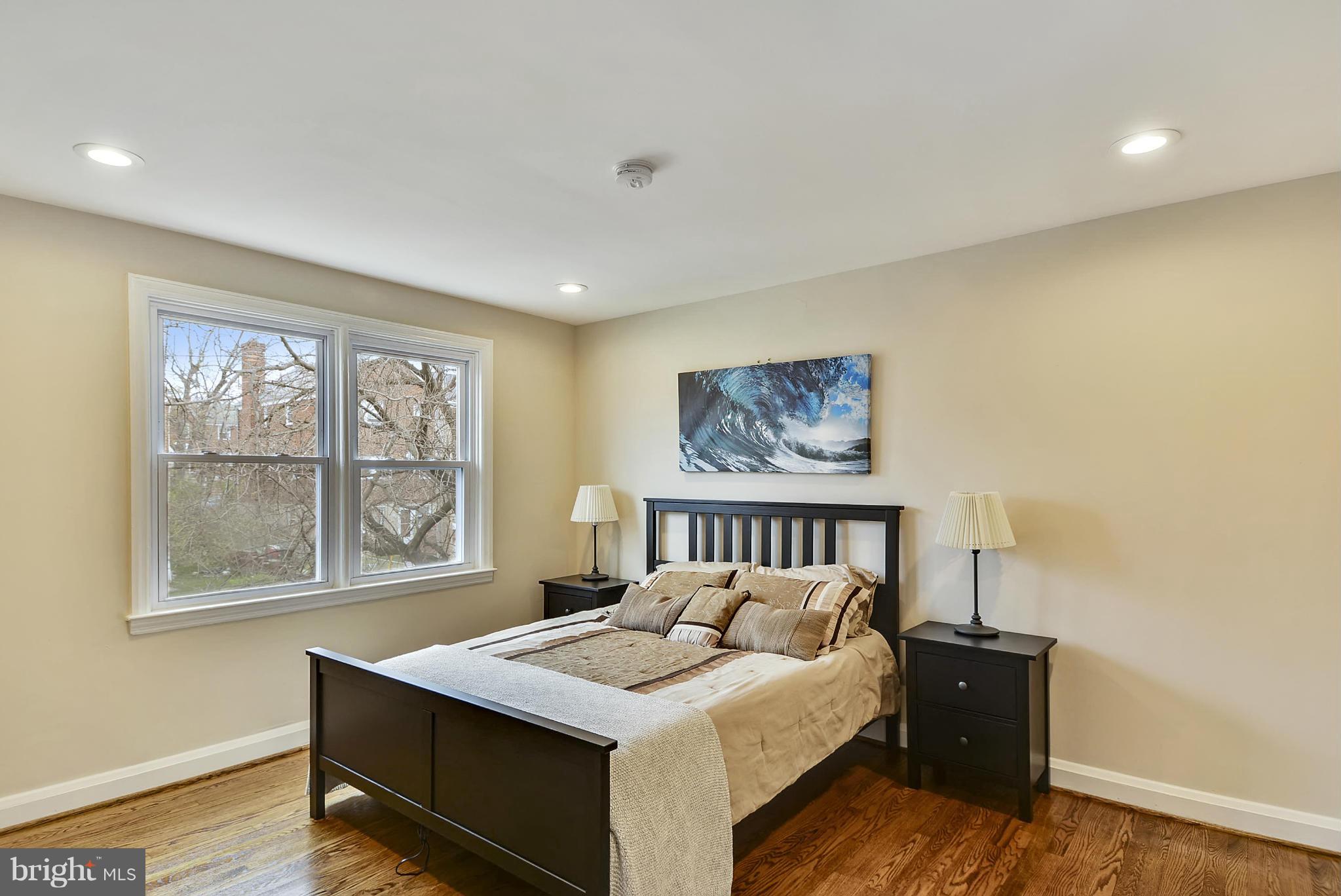 1602 Heathfield Road Baltimore, MD 21239 - Photo 14 of 27 a bed sitting in a bedroom next to a window
