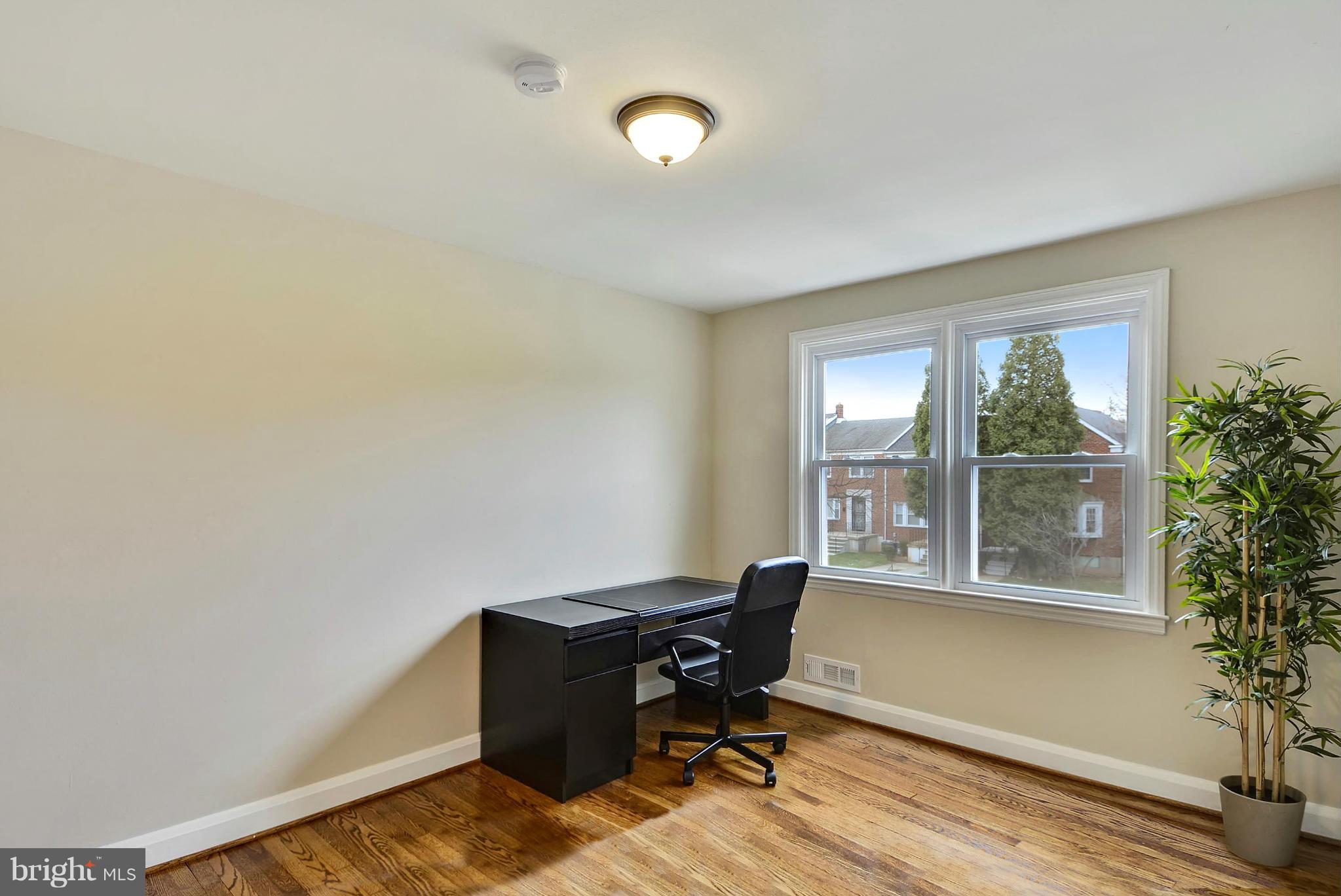 1602 Heathfield Road Baltimore, MD 21239 - Photo 18 of 27 a view of a workspace with furniture and a window