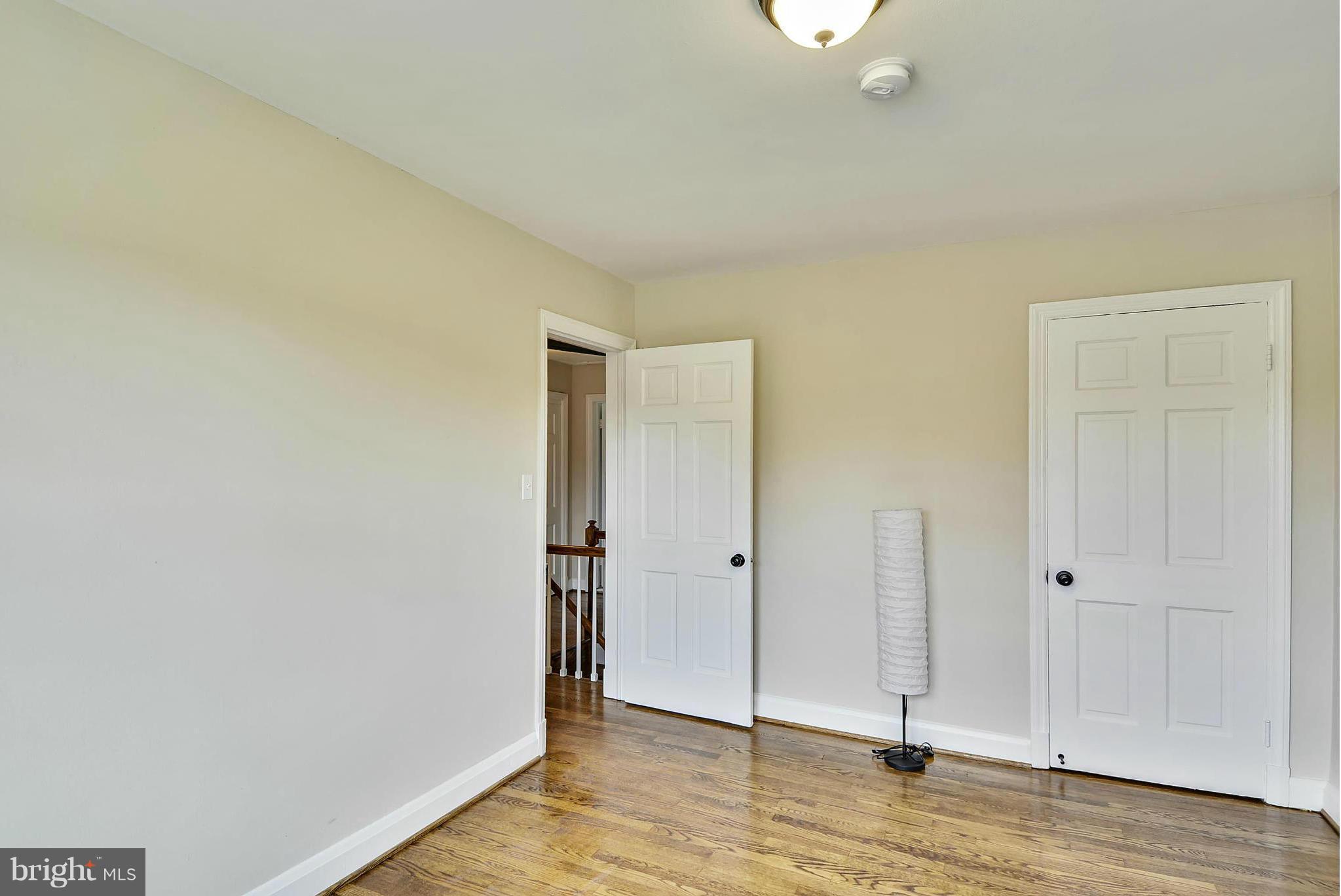 1602 Heathfield Road Baltimore, MD 21239 - Photo 19 of 27 an empty room with wooden floor and closet