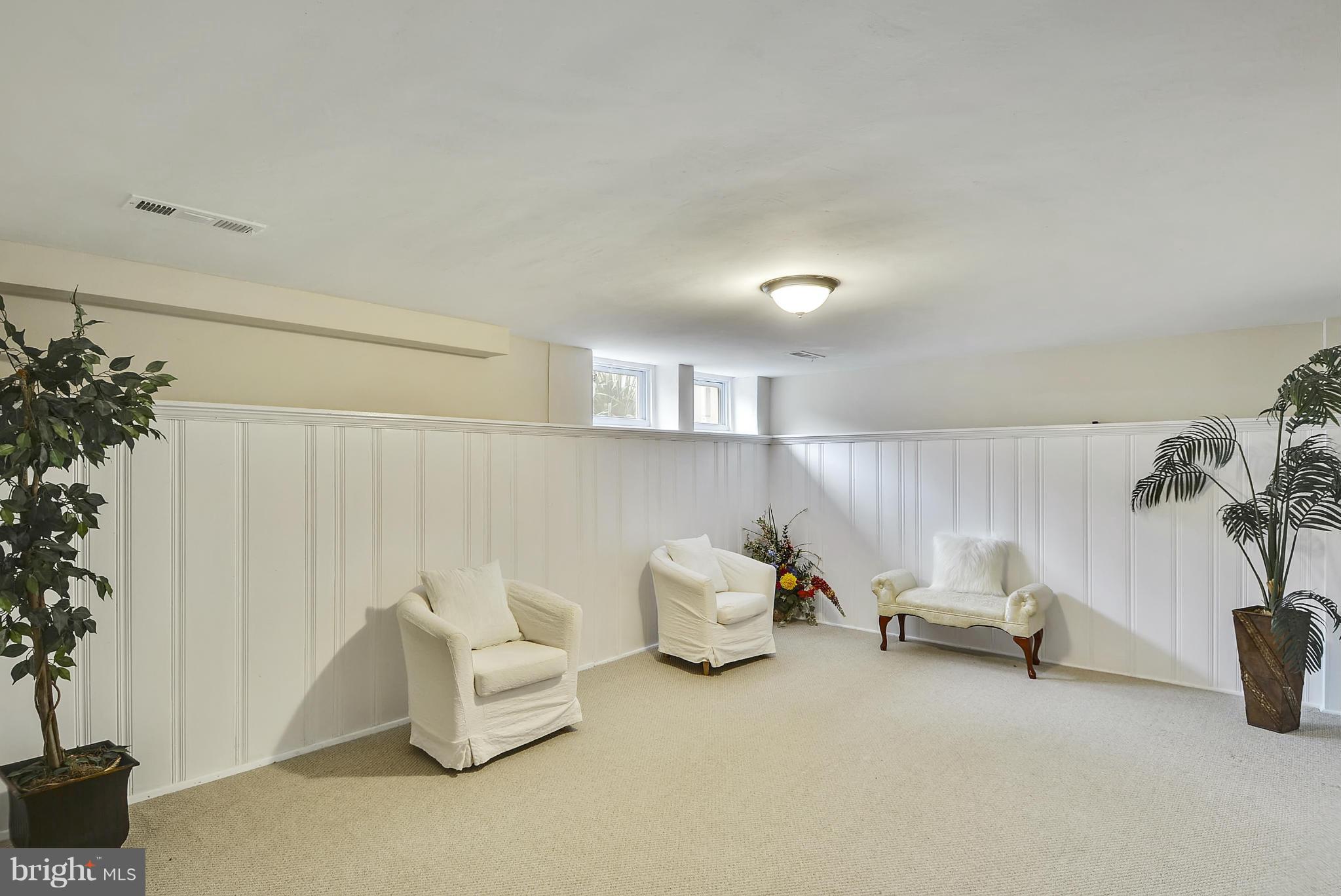 1602 Heathfield Road Baltimore, MD 21239 - Photo 22 of 27 a living room with furniture and a potted plant