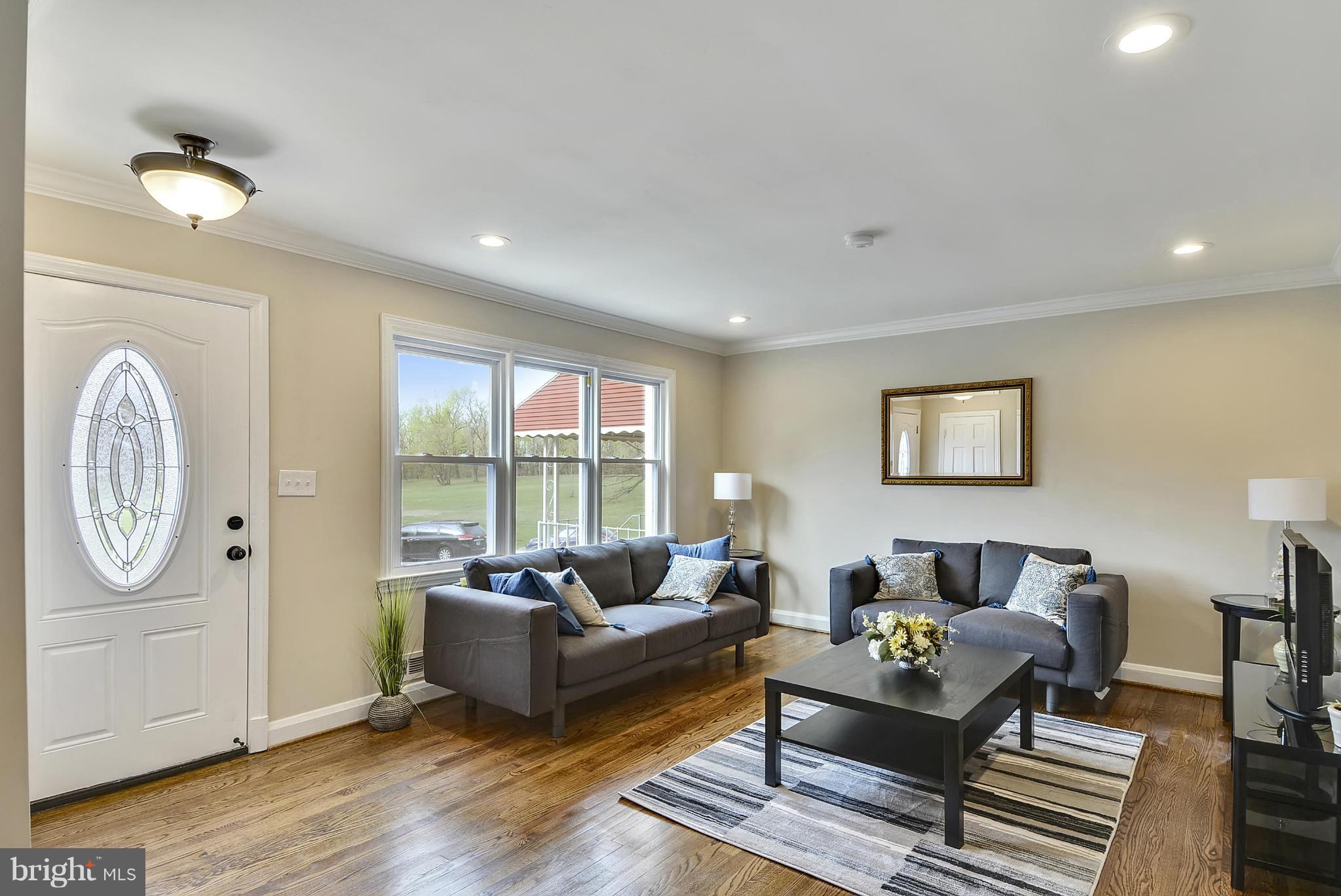 1602 Heathfield Road Baltimore, MD 21239 - Photo 7 of 27 a living room with furniture a table and a large window