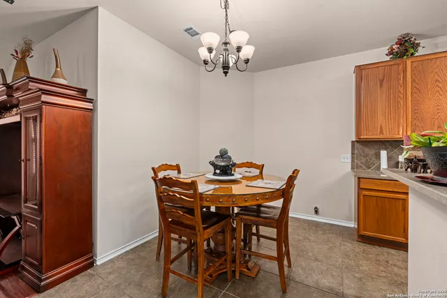 a view of a dining room with furniture and chandelier