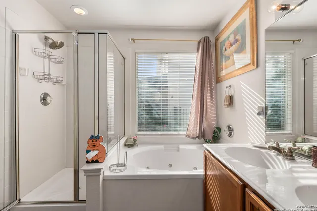 a bathroom with a tub sink and mirror