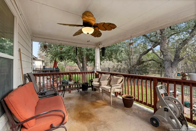a balcony with furniture and potted plants
