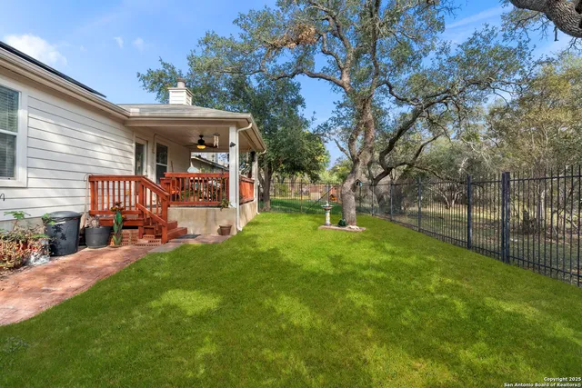a view of a house with backyard and porch