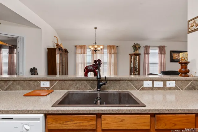 a kitchen sink with granite countertop a sink and cabinets